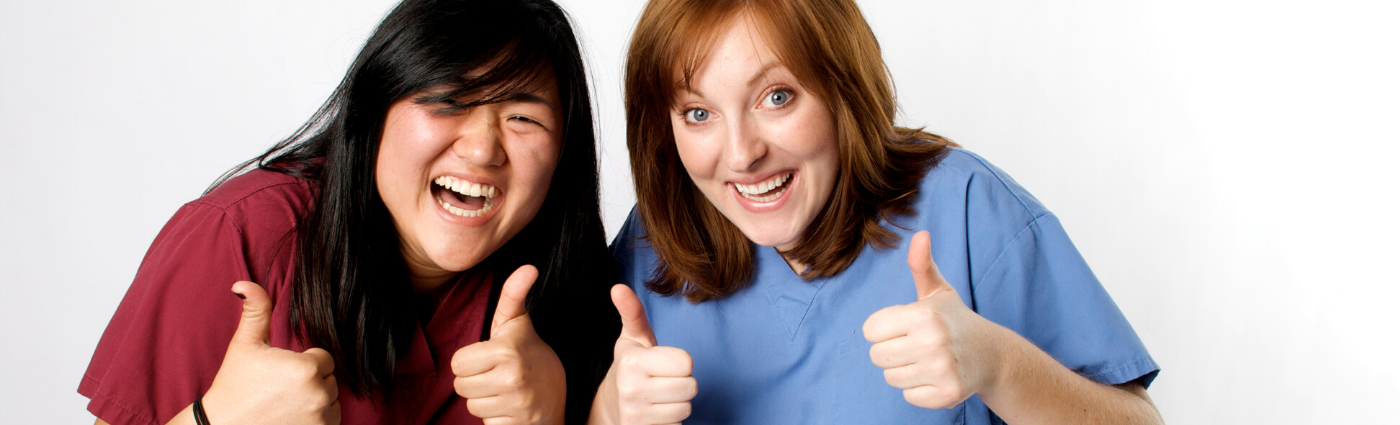 Two Nurses With Thumbs Up and Smiling