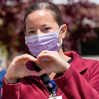 Nurse with heart hands