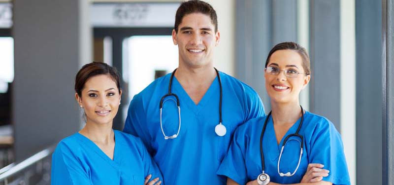 Three Nurses Looking at the Camera in a Hospital Setting