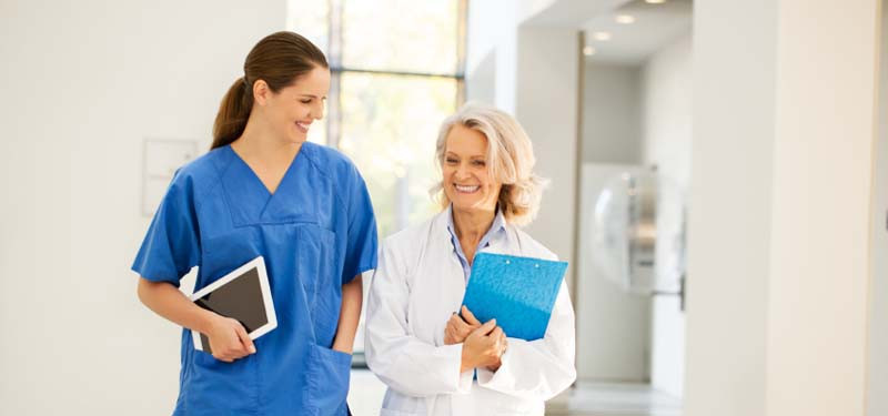 Two Nurses Walking and Smiling in the Practice Environment