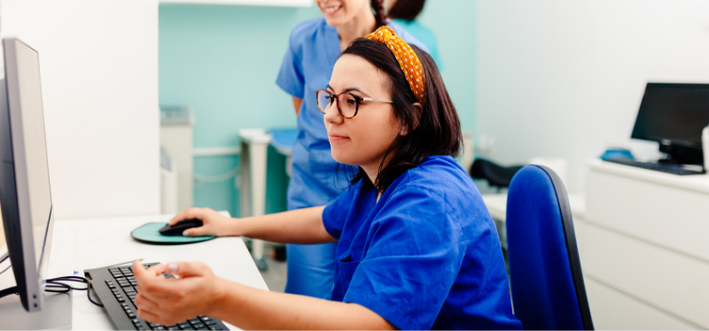 Nurse in Headband Looking at a Computer Screen
